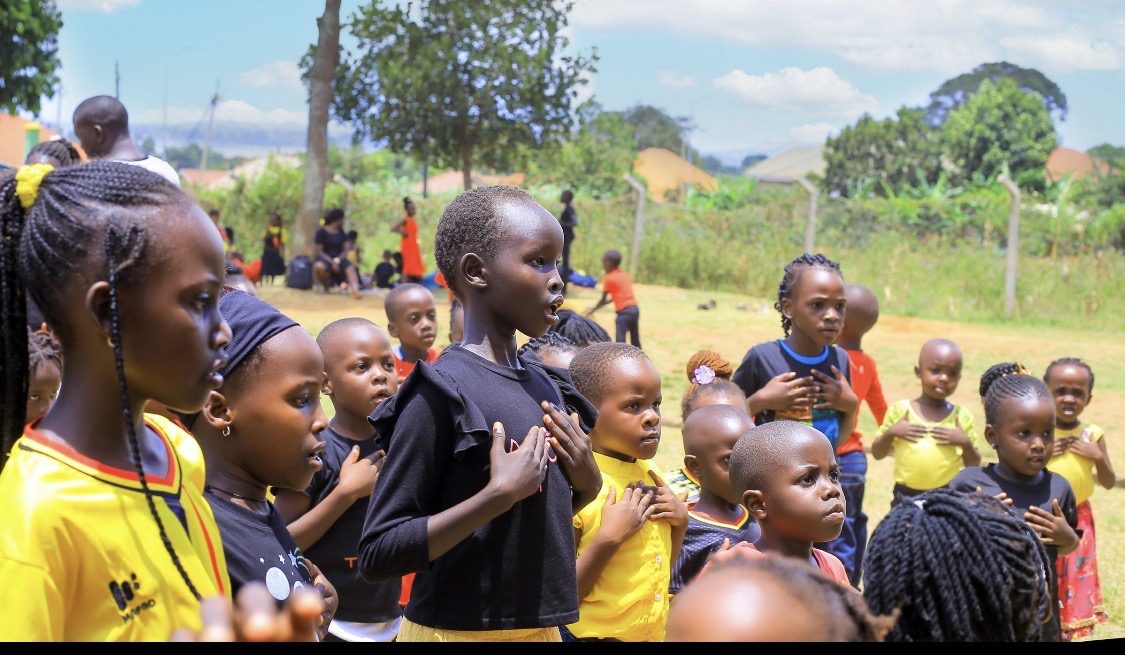 Children standing together during a values-based school activity